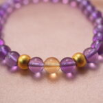 Close-up of amethyst and citrine beads showing their natural clarity and handcrafted polish.