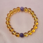 Citrine and amethyst bracelet symbolizing wealth, calm, and positive energy.