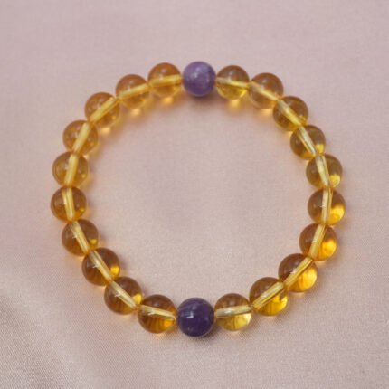 Citrine and amethyst bracelet symbolizing wealth, calm, and positive energy.