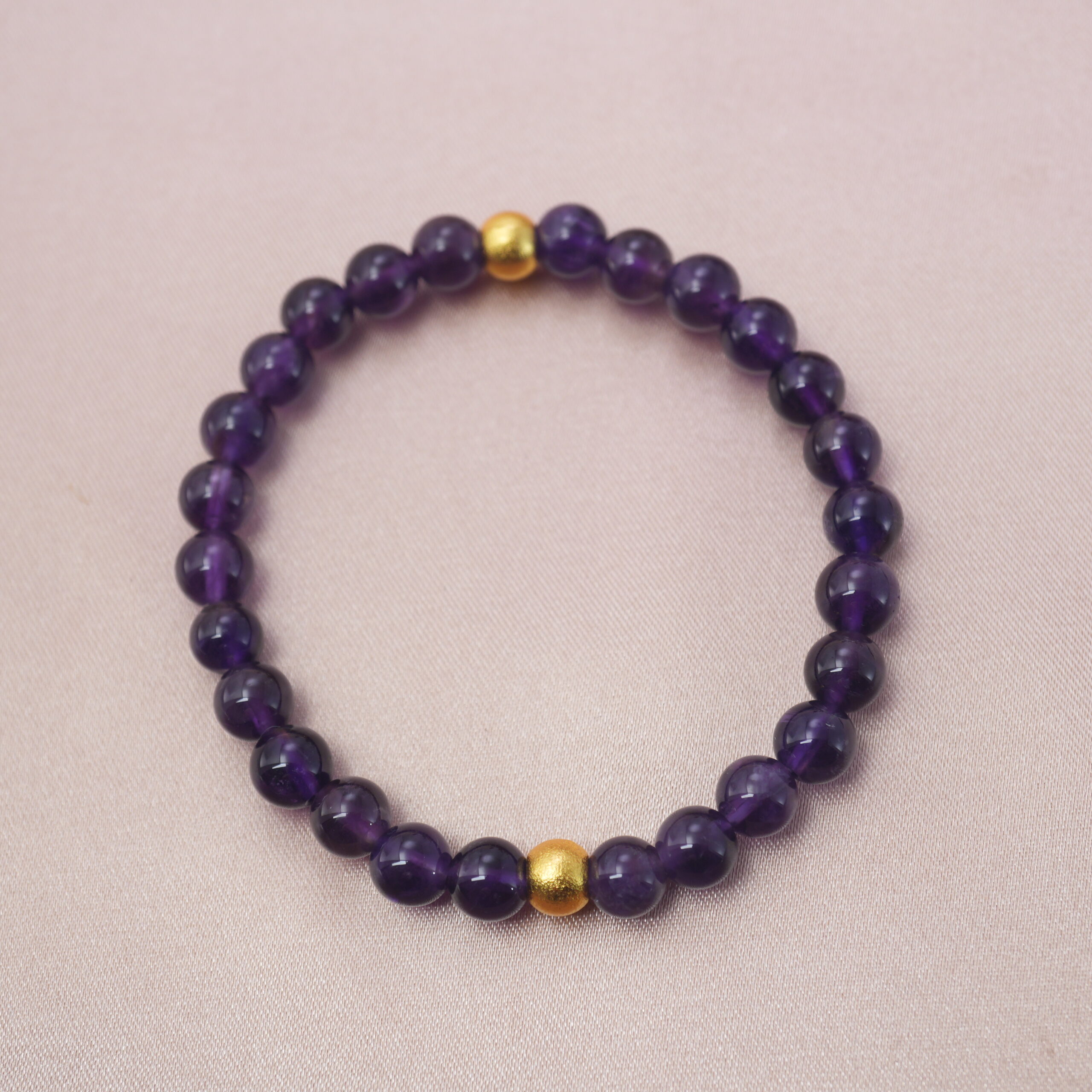deep-amethyst-gold-accent-bracelet-main.jpg Deep purple amethyst bracelet with golden beads, symbolizing calm energy and inner wisdom.
