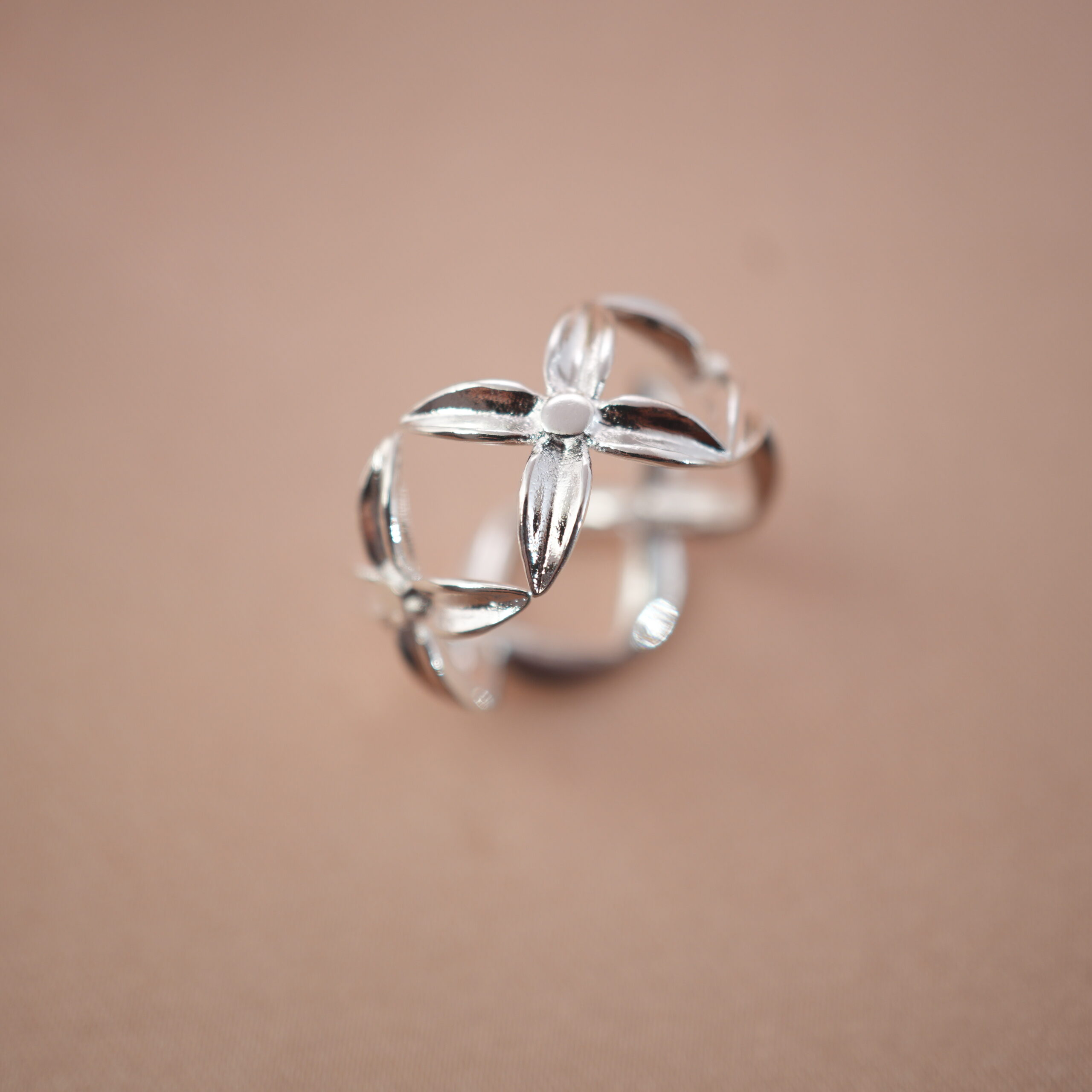 silver-blossom-adjustable-ring-main.jpg Silver adjustable ring with open floral petal design, symbolizing elegance and renewal.