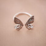Silver butterfly wing adjustable ring featuring an open design symbolizing freedom and transformation.
