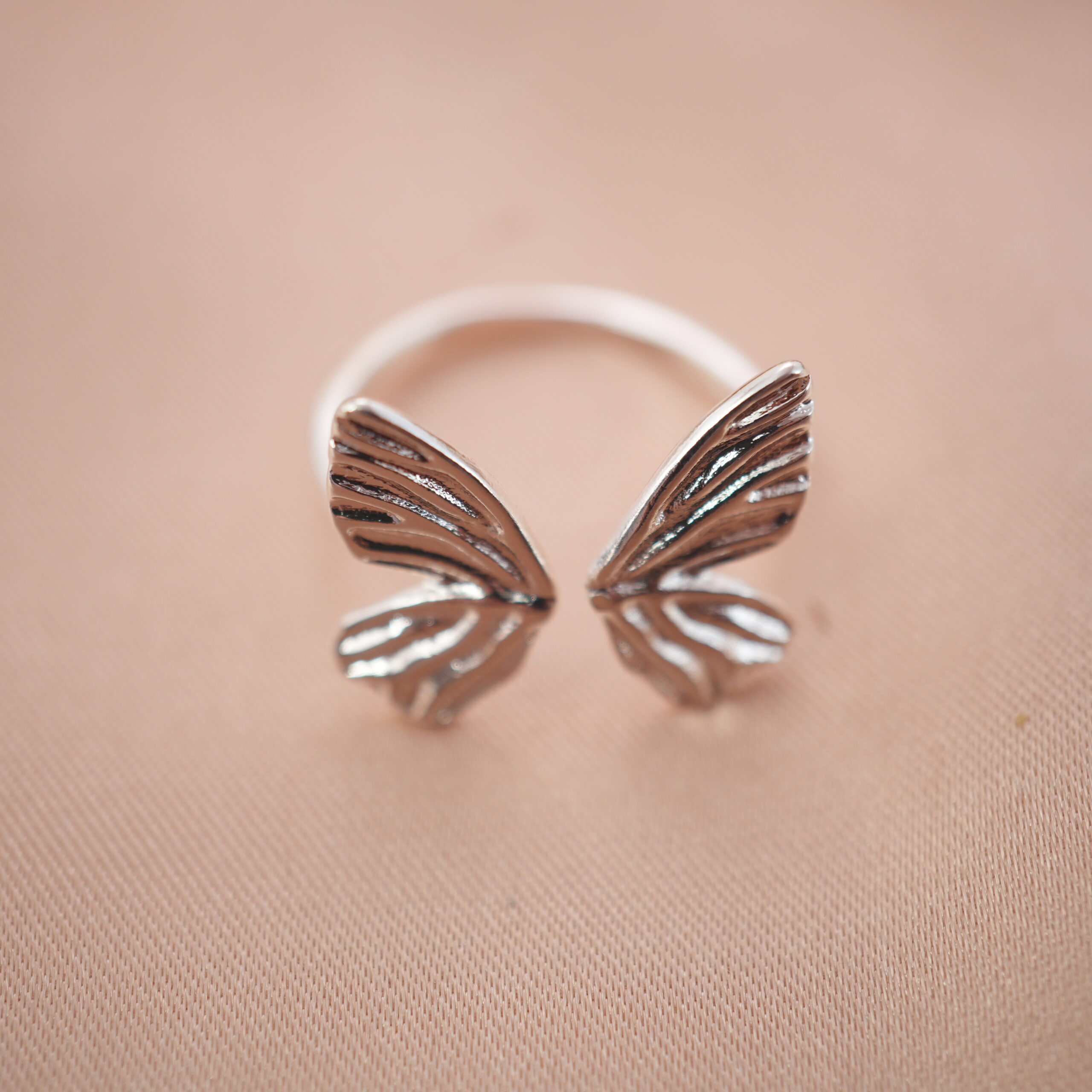 silver-butterfly-wing-adjustable-ring-main.jpg Silver butterfly wing adjustable ring featuring an open design symbolizing freedom and transformation.