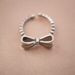 Close-up of vintage bow silver ring highlighting its smooth ribbon curves and handcrafted texture.