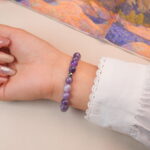 Back view of the amethyst bracelet showing smooth round crystals and silver accent bead.