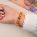 Back view of citrine bracelet with silver spiral accent, radiating natural golden glow.