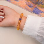 Back view of citrine bracelet with amethyst accent, radiating warmth and peaceful charm.