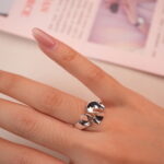 Silver petal open ring worn on hand, showcasing its modern minimalist style.