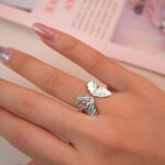 Elegant silver butterfly wing ring worn on hand, showing a graceful and feminine look.