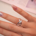 Elegant silver flower ring worn on hand, showing delicate and feminine style.