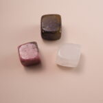 Set of three crystal cubes – labradorite, rhodonite, and clear quartz – symbolizing calm, balance, and protection.