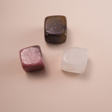 Set of three crystal cubes – labradorite, rhodonite, and clear quartz – symbolizing calm, balance, and protection.