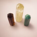 Set of three crystal points – smoky quartz, citrine, and amazonite – symbolizing wealth, positivity, and balance.