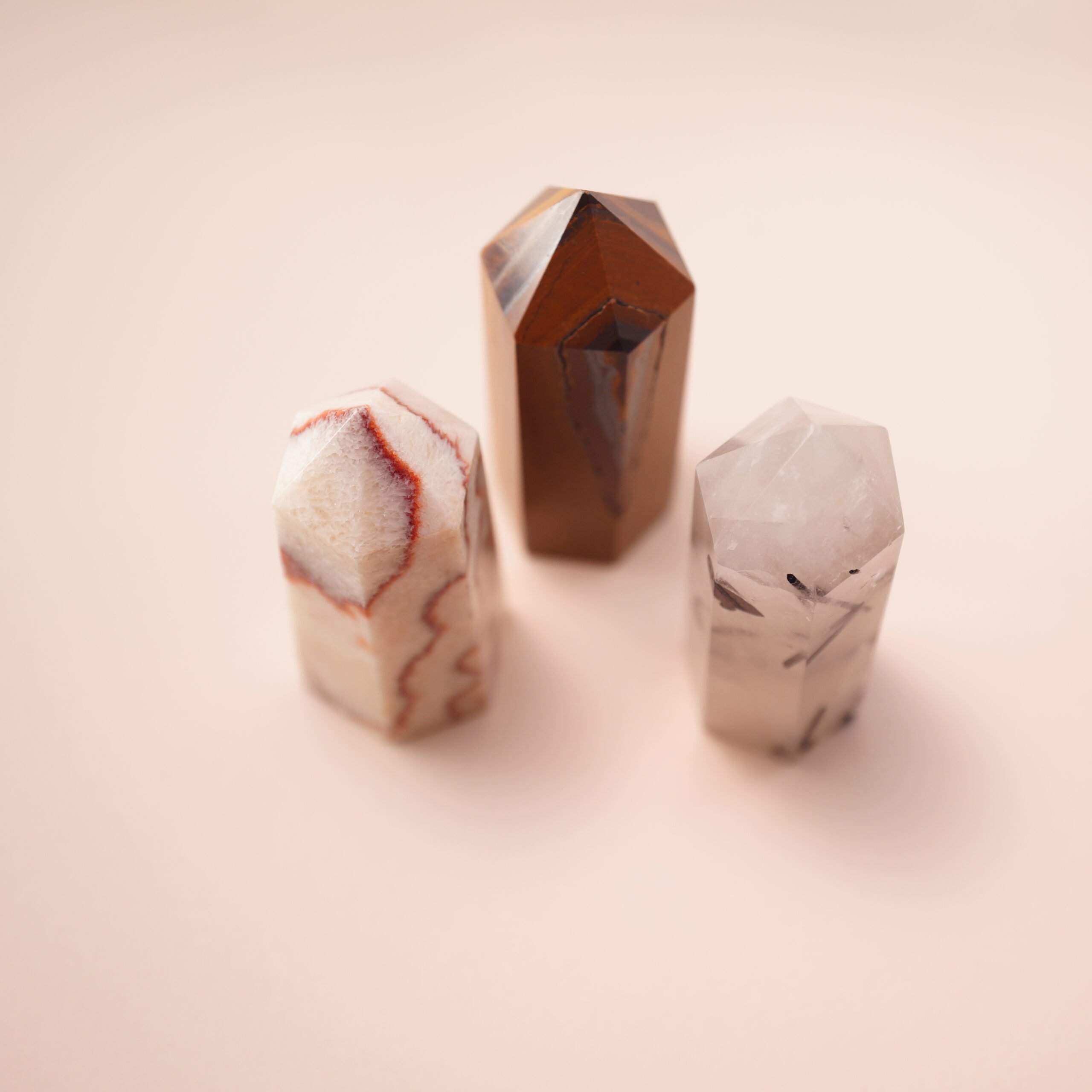 trinity-crystal-point-set-main.jpg Set of three crystal points – red jasper, tiger’s eye, and tourmalinated quartz – representing grounding and balance.