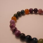 Close-up detail of multicolor tourmaline bracelet showing the polished surface, vibrant gemstone hues, and natural color transitions from pink to green.2