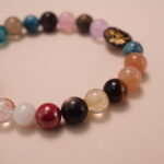 Close-up detail of multicolor gemstone bracelet showing the variety of natural stones and decorative beads, highlighting the polished finish and vivid color contrasts.2