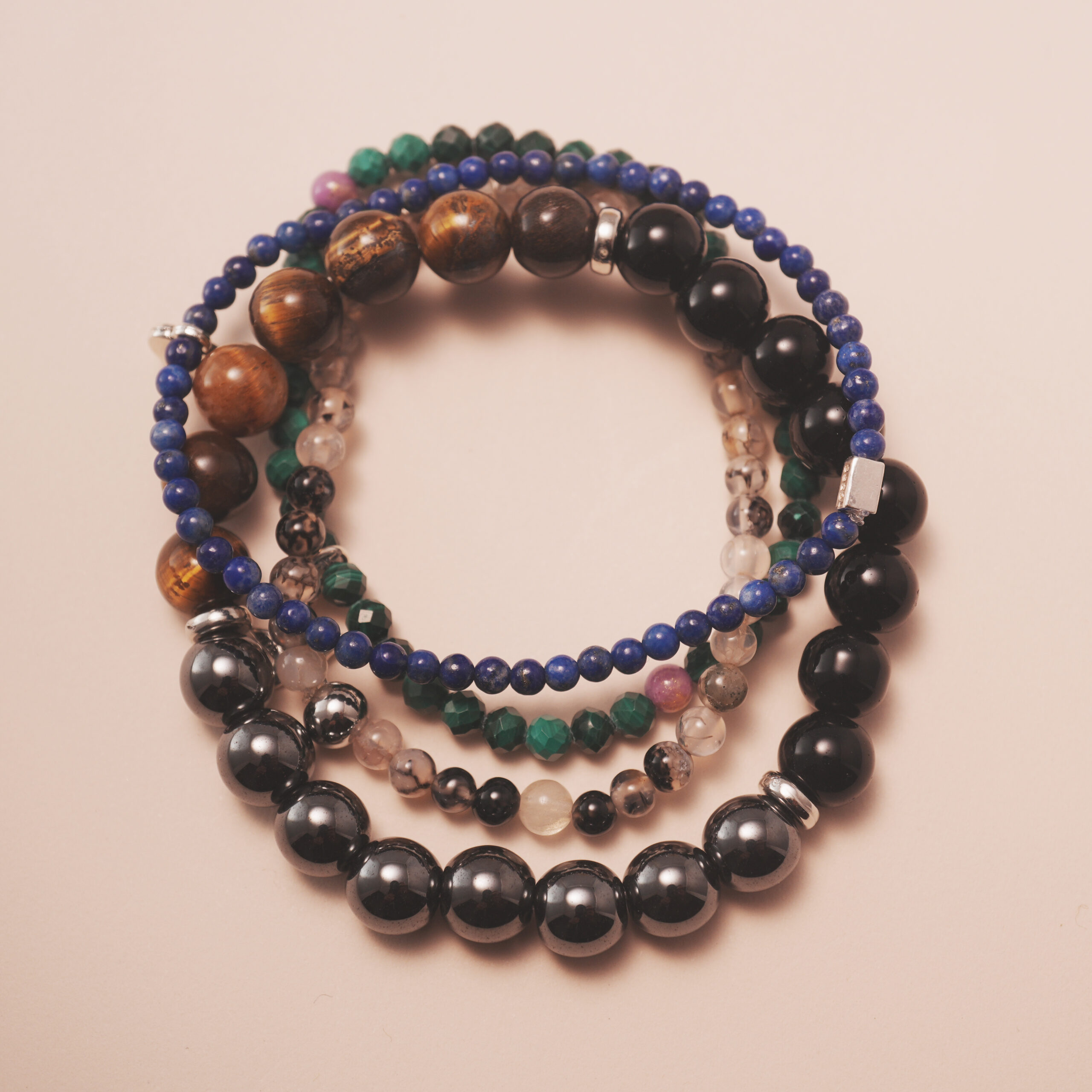 protection-crystal-bracelet-stack-dark-main.jpg Protection crystal bracelet stack designed for grounding, strength, and emotional balance.