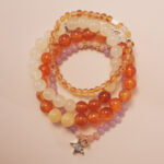 Vitality bracelet stack with carnelian, citrine, and white chalcedony beads, radiating warmth and energy.