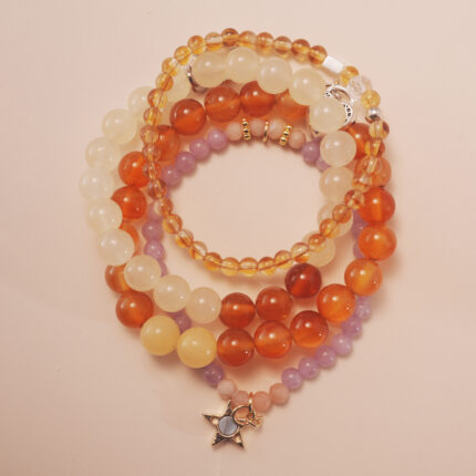 Vitality bracelet stack with carnelian, citrine, and white chalcedony beads, radiating warmth and energy.