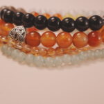 Decorative charm detail from the Solar Energy bracelet stack symbolizing creativity and inspiration.