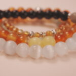 Close-up of the Solar Energy bracelet stack showing glowing tones and vibrant gemstone reflections.