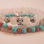 Close-up of the love bracelet stack showing delicate beads and gentle harmony of colors.