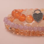 Close-up of orange carnelian and golden citrine beads showing their radiant texture and vitality energy.