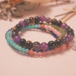 Protection bracelet stack placed in a serene natural setting, radiating grounding and peaceful energy.