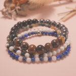 Midnight Guardian bracelet stack displayed in a serene natural setting, radiating grounding and protective energy.