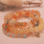 Golden Glow wealth bracelet stack displayed in a warm natural setting, radiating joyful and prosperous energy.
