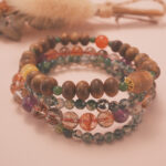 Wealth bracelet stack displayed in a warm natural setting, radiating luck and abundance.