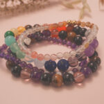 Rainbow Fortune bracelet stack displayed in a warm natural setting, radiating happiness and luck.