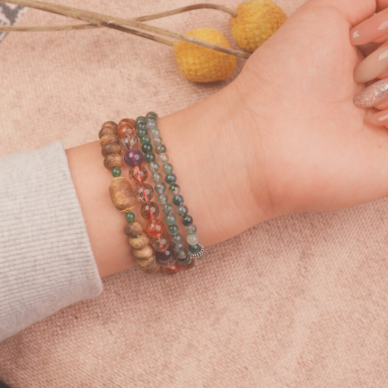 Model wearing the wealth crystal bracelet stack — a daily charm for success and good fortune.