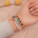 Model wearing the Blossom Heart bracelet stack — a radiant expression of love and tenderness.