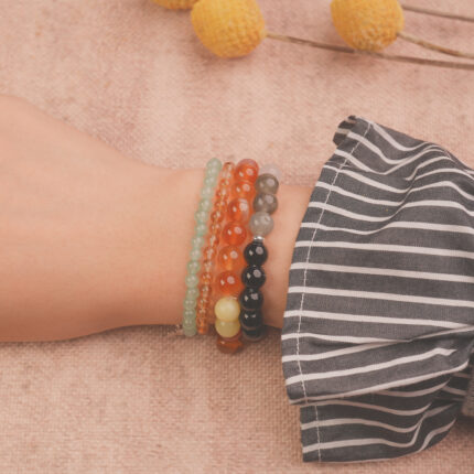 Model wearing the Solar Energy bracelet stack — a radiant accessory for strength and motivation.