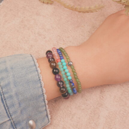Model wearing the protection crystal bracelet stack — a daily reminder of calmness, strength, and inner harmony.