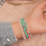 Model wearing the love crystal bracelet stack — a daily reminder of warmth, kindness, and compassion.