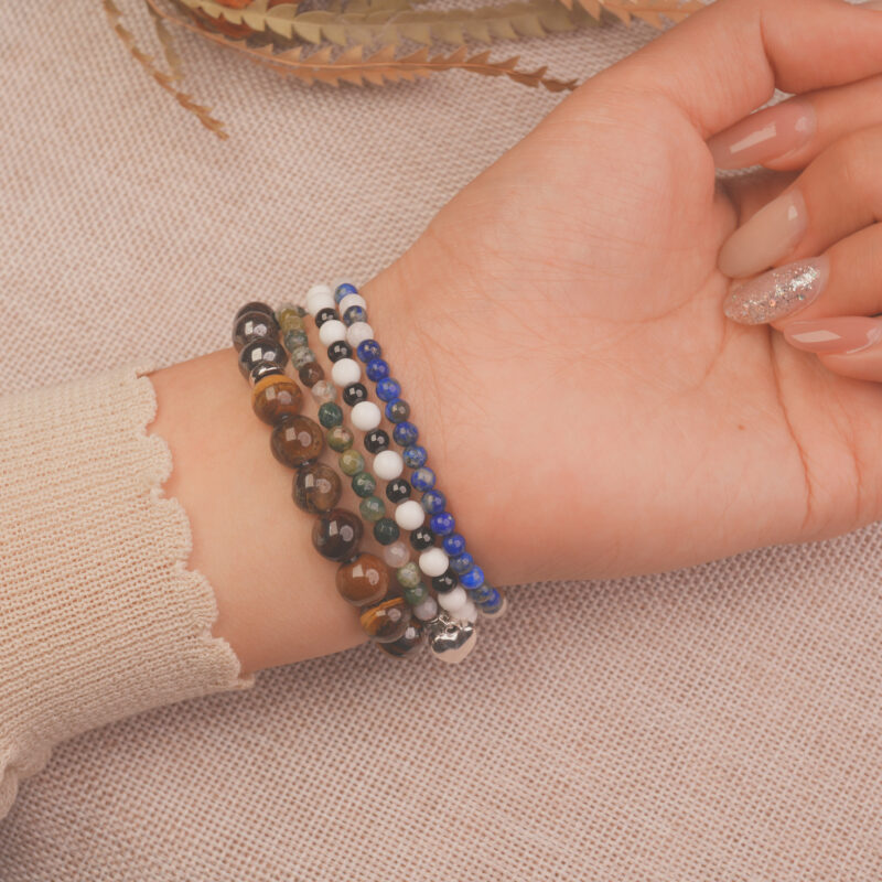 Model wearing the Midnight Guardian bracelet stack — a symbol of calm strength and inner protection.