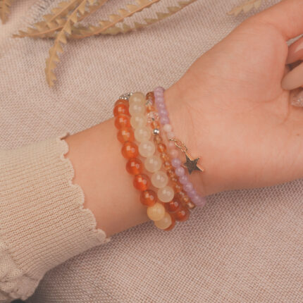 Model wearing the Sunrise Glow vitality bracelet stack, expressing optimism and radiant charm.