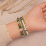 Model wearing the Fortune Grove good luck bracelet stack, expressing joyful energy and fresh opportunities.