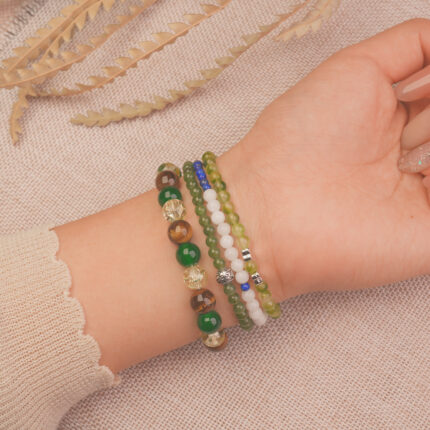 Model wearing the Fortune Grove good luck bracelet stack, expressing joyful energy and fresh opportunities.