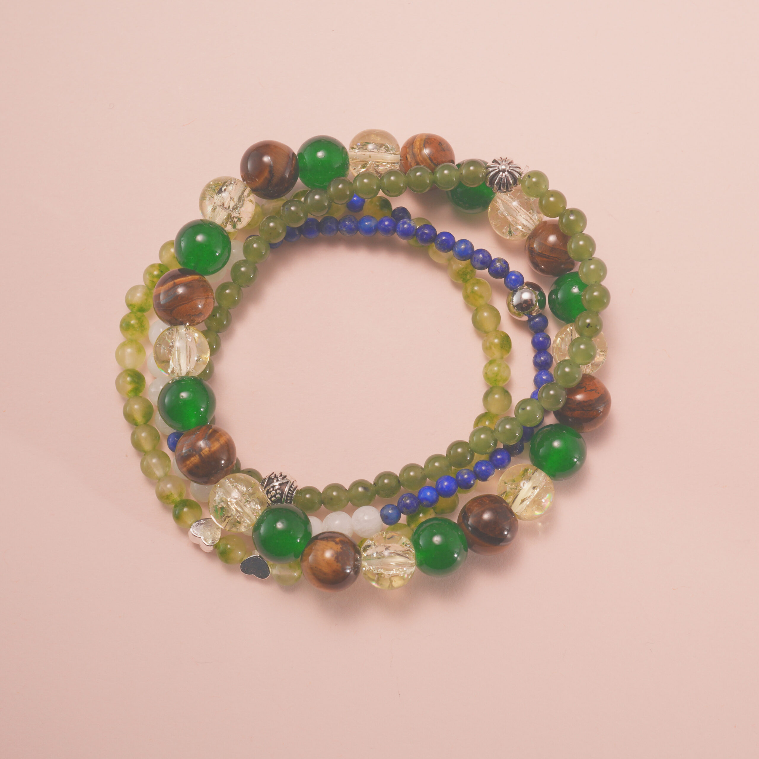 fortune-grove-good-luck-intention-bracelet-stack-main.jpg Good luck intention bracelet stack with green and golden gemstones, symbolizing growth, positivity, and fortune.
